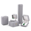 Light gray luxury jewelry box set with white velvet interior and gold clasp accents - Gray