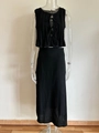 Detail of black two-piece set with pleated texture, sleeveless tie-front top and long skirt - Black Zirconia Set