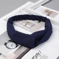 Detail view of navy blue ribbed knit headband with cross knot design on minimalist background - Knitted Navy Blue