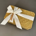 Detail of a rectangular seagrass gift box featuring a white satin ribbon and pearl tag - Milky White (DIY Ribbon)