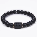 Detail of Virgo zodiac sign engraved on black matte bead bracelet with rose gold spacers - Virgo