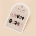 Detail of pink and black handmade press-on nails with heart rhinestones and zebra patterns - By1763 / Glue Type
