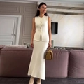 Elegant cream knit set featuring a sleeveless vest with gold buttons and a midi skirt - S / Milky White