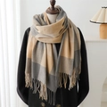 Close-up of beige and grey plaid scarf with soft fringe detail on a mannequin - Rice Camel