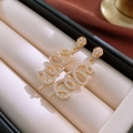 Close-up of golden teardrop earrings with spiral pavé rhinestones in a gift box - 13# Silver Earring Post - Gold Rhinestone Spiral Snake
