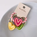Set of three colorful braided hair ties with heart-shaped resin charms in pastel colors - Heart