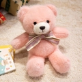 Pink plush teddy bear with striped LOVE bow tie on a soft white decorative rug - Pink Bow Tie