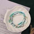 Detail of colorful seed bead bracelets with evil eye charm on white shell plate - Style 46-4pcs Evil Eye Set