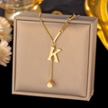 Gold plated stainless steel necklace featuring letter K pendant and a polished cube charm - Letter K-Gold