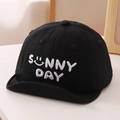 Detail of sunny day letter embroidery on a black soft brim baby baseball cap - 50cm / Black