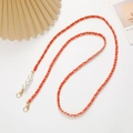 Detail of red leather woven gold chain strap with elegant pearl accents and lobster clasps - Crossbody Chain / Orange (K2226)