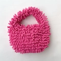 Macro shot of fuchsia chenille mop plush texture on a stylish small square handbag - Rose Red