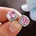Macro detail of square-cut pink zircon stud earrings with classic halo diamond setting - Pink