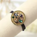 Detail of baroque hair tie with colorful crystal inlay and gold-tone metal pendant - Round Style