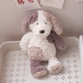 Patchwork plush puppy toy with white and dark brown faux fur in a cozy storage basket - White Dog