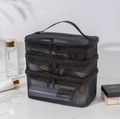 Three-layer black mesh toiletry bag with handle and double zippers on marble surface - Triple Layer / Black