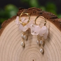 Elegant vintage natural pearl earrings with pink crystal stones on wood background - Rose Quartz