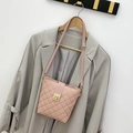 Light pink quilted crossbody bag with gold metallic lock and adjustable leather strap - Pink