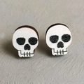 Detailed view of spooky black and white skull stud earrings for Halloween accessories - Skull