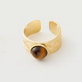 Detailed close-up of retro gold steel ring with brown gemstone and wavy carvings - Adjustable Open / Brown