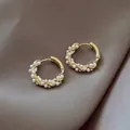 Macro detail of gold twisted hoop earrings with white pearls on a silk background - Gold Wrapped Pearl
