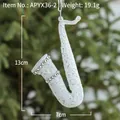 Sparkly white saxophone Christmas tree ornament with rhinestones hanging on a branch - White Musical Instrument B