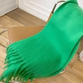 Vibrant green mohair scarf with tassels draped on a modern chair in a cozy room - Grass Green