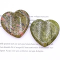 Polished unakite and green natural crystal heart stones on a white background - Unakite