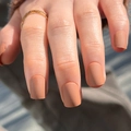 Matte terracotta press-on nails in short square shape shown with a gold ring accessory - Matte Terracotta (JP3184)