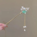 Golden hair stick with white flowers green leaves and pearl tassels in hand - F0509 Glaze