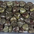 Polished heart-shaped natural stones in red and olive green patterns stacked together - Dragon Blood Stone