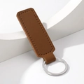 Minimalist brown leather car keychain accessory with silver metal ring on white background - Rectangle / Coffee