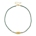 Detail van de turquoise kralenketting met gouden boze oog hanger en verlengketting - Turkoois Kralen - Roze Oog