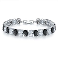 Close-up of luxury tennis bracelet with black and white oval crystals in polished silver setting - Platinum Black Zirconia (068)