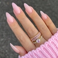Golden ring set with pink heart stone and wavy band worn on a hand with pink sweater - Glossy Finished / Pink with Rings