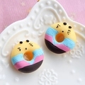 Close-up of colorful resin donuts with cute expressions for DIY jewelry and phone cases - Yellow Base - Blue Pink Coffee