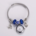 Detail of quartz watch bracelet with blue enamel flower and swan charms in silver - Sky Blue