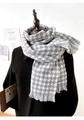 Classic grey and white houndstooth cashmere scarf with tassel trim on a black coat - Large Houndstooth Grey