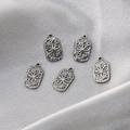 Five vintage stainless steel rectangular starburst charms on silver silk fabric - Silver