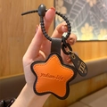 Orange star-shaped PU leather keychain with black leather strap and debossed detail - Leather-Orange Star