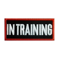 In Training dog harness patch with white embroidery and red border on black fabric - IN TRAINING (Red Border)