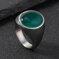 Silver stainless steel ring featuring a round green gemstone on a dark textured surface - 6 / Oval Green Gemstone / Silver