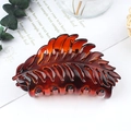Elegant amber brown leaf shaped matte hair claw clip for bun hairstyles on white desk - Glossy Coffee