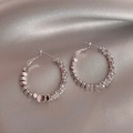 Macro view of vintage silver hoop earrings with zircon stones on silk fabric - Zircon Crushed Silver Hoop Earrings