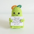 Handmade green knitted pear doll holding a motivational white card for desk decoration - Green Pear
