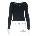 Close-up of black slim-fit long sleeve top featuring intricate lace trim at the neckline - S / Black