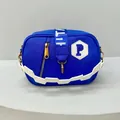 Detail of royal blue nylon crossbody bag featuring white zigzag handle and golden hardware - Blue