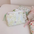 Close-up of assorted floral quilted cotton mini pouches with metal zippers and pull cords - Green Leaf Purple Floral