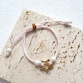 Pink braided rope bracelet featuring a golden star charm and white bead accents - Pink Woven Rope Golden Hollow Star Bracelet