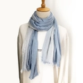 Blue and grey gradient linen scarf with pleated texture and fringe on a mannequin - Light Blue